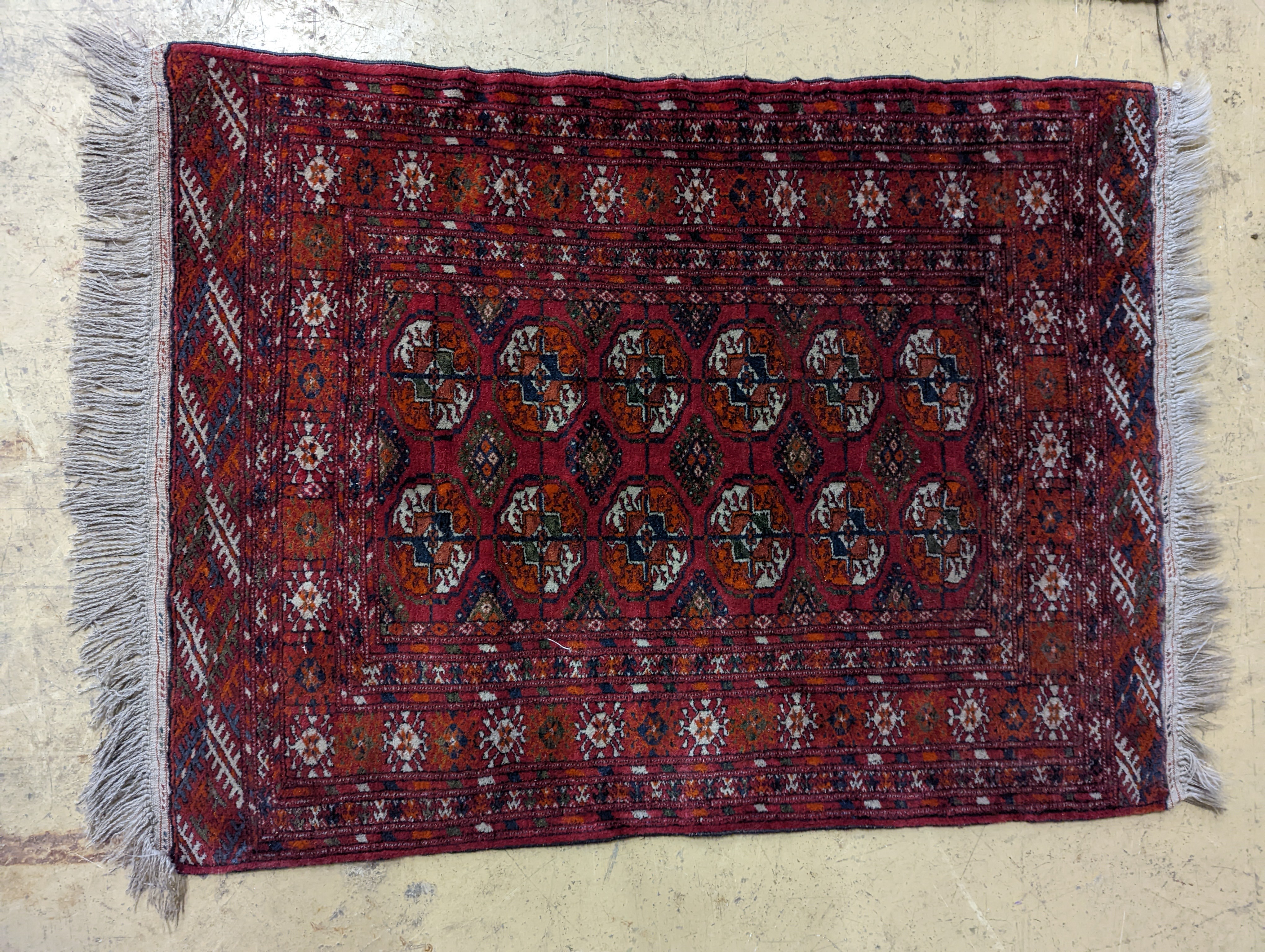 A Bokhara red ground rug and a Belouch prayer rug, larger 144 x 88cm
